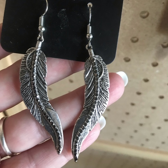Silver feather earrings w/tiny rhinestone centers.